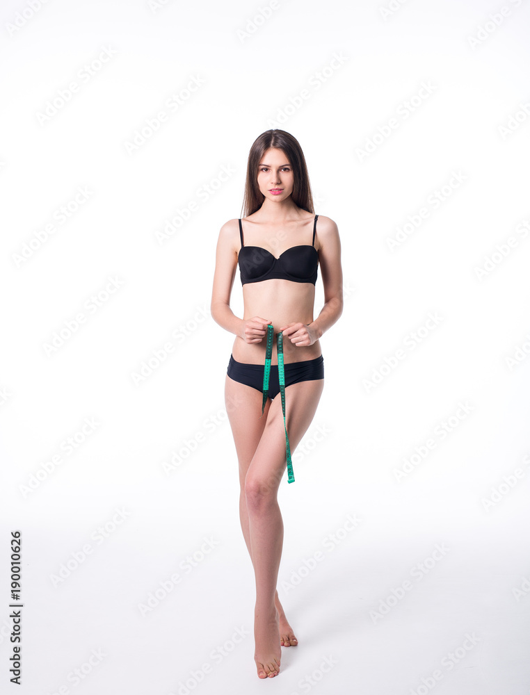 Portrait of attractive caucasian smiling woman with measuring tape isolated on white background - obrazy, fototapety, plakaty 