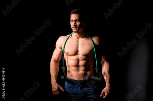 Fitness concept. Muscular and sexy torso of young man having perfect abs, bicep and chest. Male hunk with athletic body.