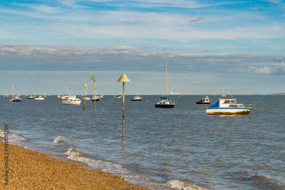 Boats on the shore of the River Thames, seen in Southend-on-Sea, Essex, England, UK