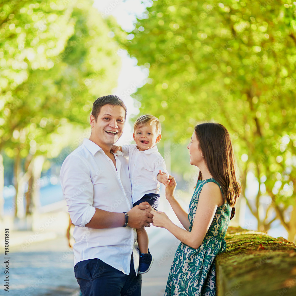 Fototapeta premium Happy family of three enjoying their vacation in Paris