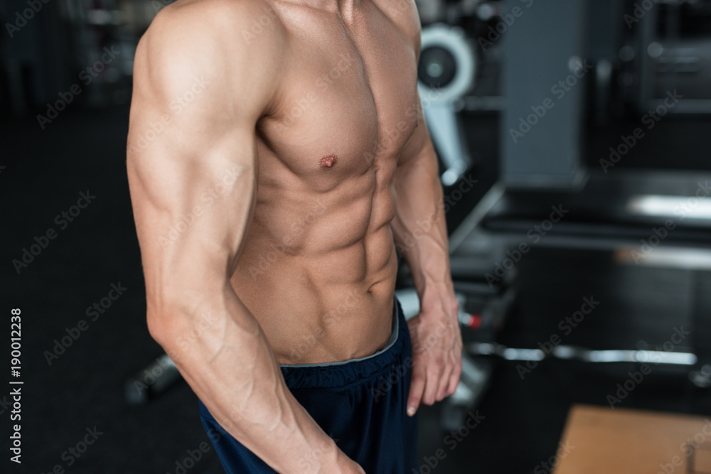 Fitness concept. Muscular and sexy torso of young man having perfect abs, bicep and chest. Male hunk with athletic body. Fitness concept. Muscular and sexy torso of young man having perfect abs, bicep and chest. Male hunk with athletic body.
