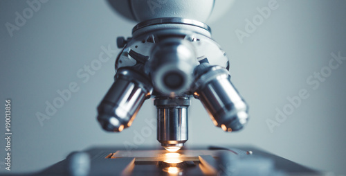 Fotografía Close up of examining of test sample under the microscope in laboratory