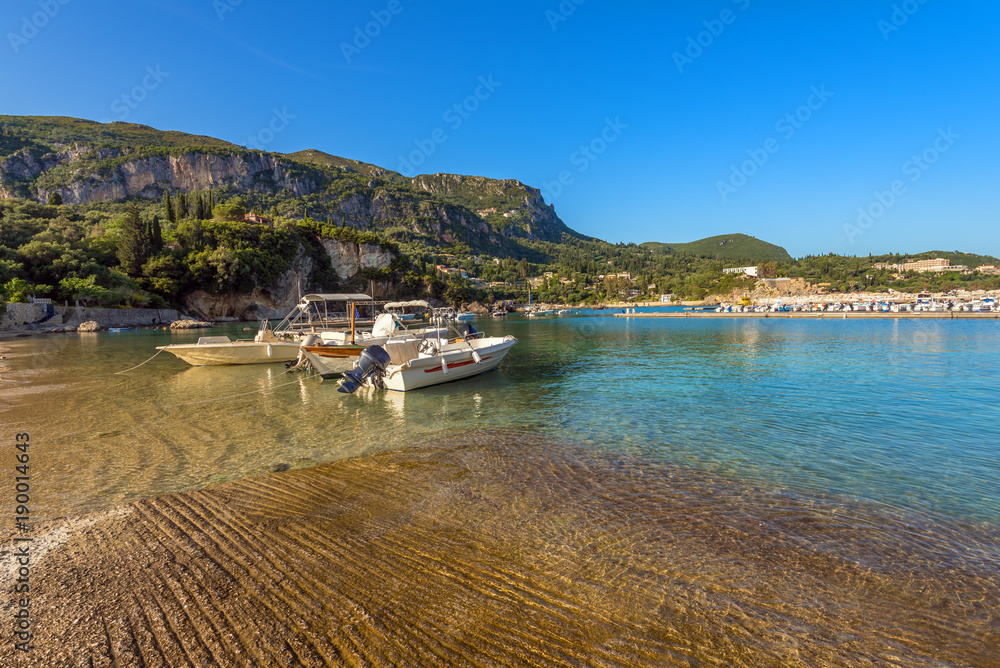 Boats on azure sea in Palaiokastritsa harbour. Corfu island, Greece Boats on azure sea in Palaiokastritsa harbour. Corfu island, Greece