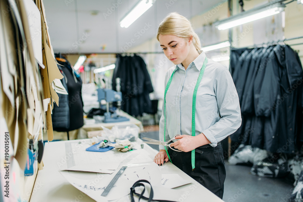 Clothes designer measures a pattern, sewing Clothes designer measures a pattern, sewing