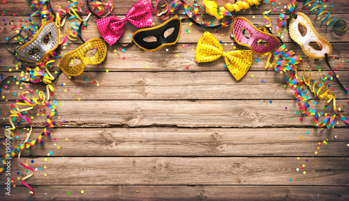 Colorful carnival or party frame of masks, streamers and confetti