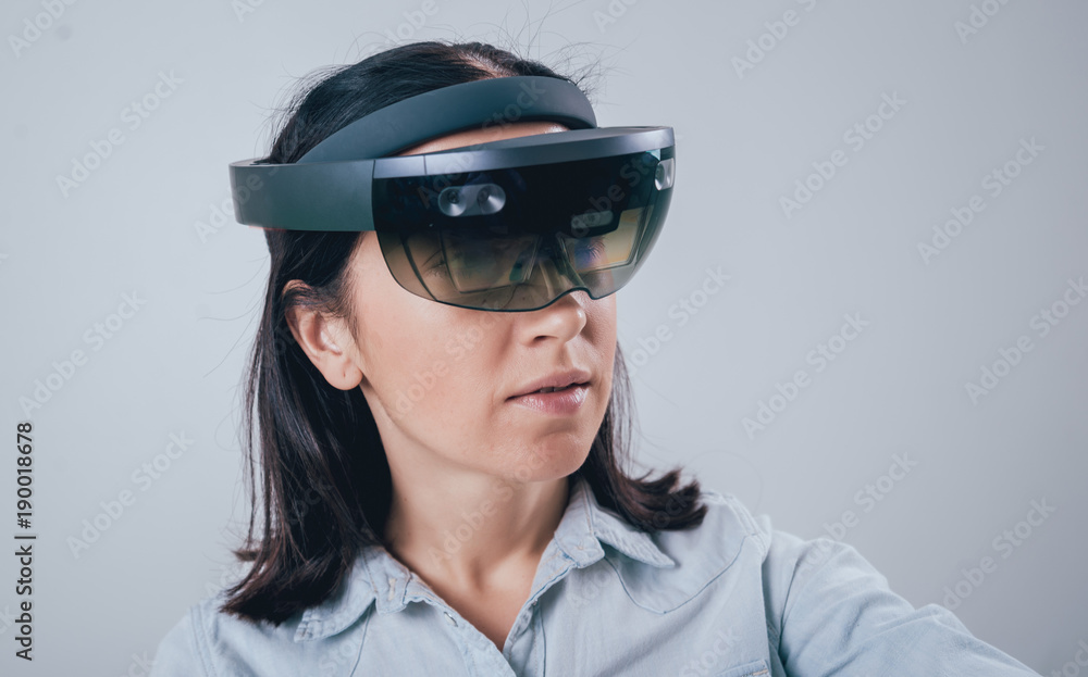 Woman wearing augmented reality goggles. Woman wearing augmented reality goggles.