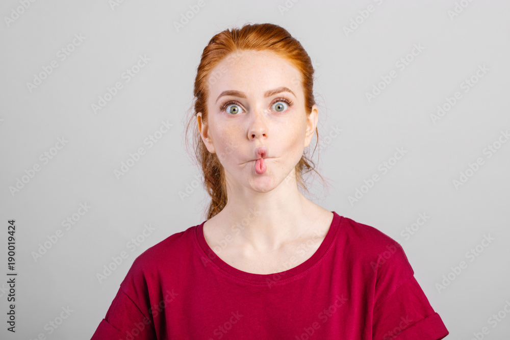 Gorgeous Caucasian woman pretends to be kissing doing fish face isolated on  whute background Stock Photo