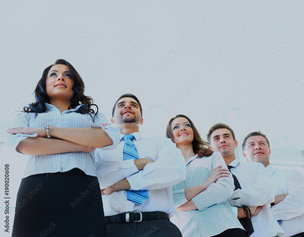 Obraz premium Happy young business woman with her team in background.