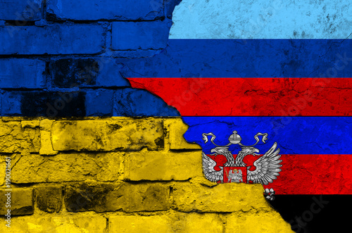 Flag of Ukraine and Donetsk and Lugansk People's Republic on a textured brick wall photo