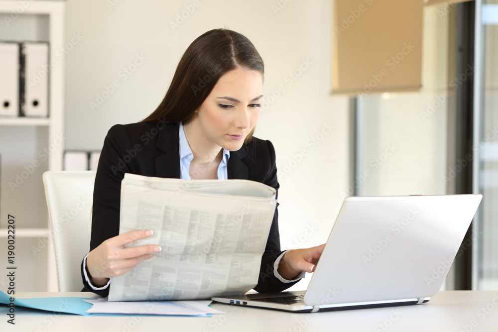 Businesswoman working reading a newspaper Businesswoman working reading a newspaper
