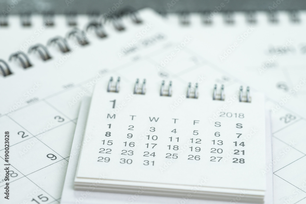 Clean white calendar business deadline, time passing, year planning or appointment reminder concept by pile of white and clean paper calendars on office table Clean white calendar business deadline, time passing, year planning or appointment reminder concept by pile of white and clean paper calendars on office table
