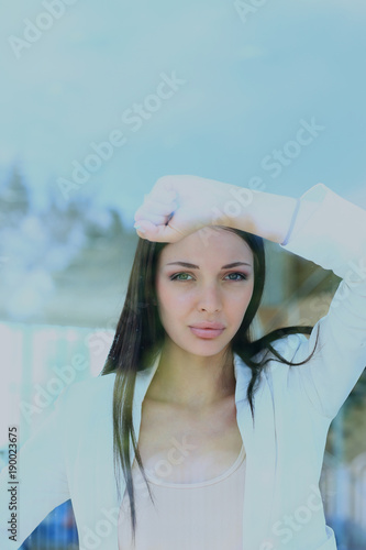 business woman looking thtough window in the office. photo