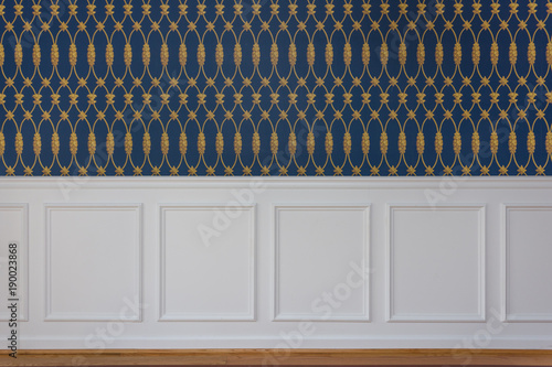 White wood trim and blue wallpaper