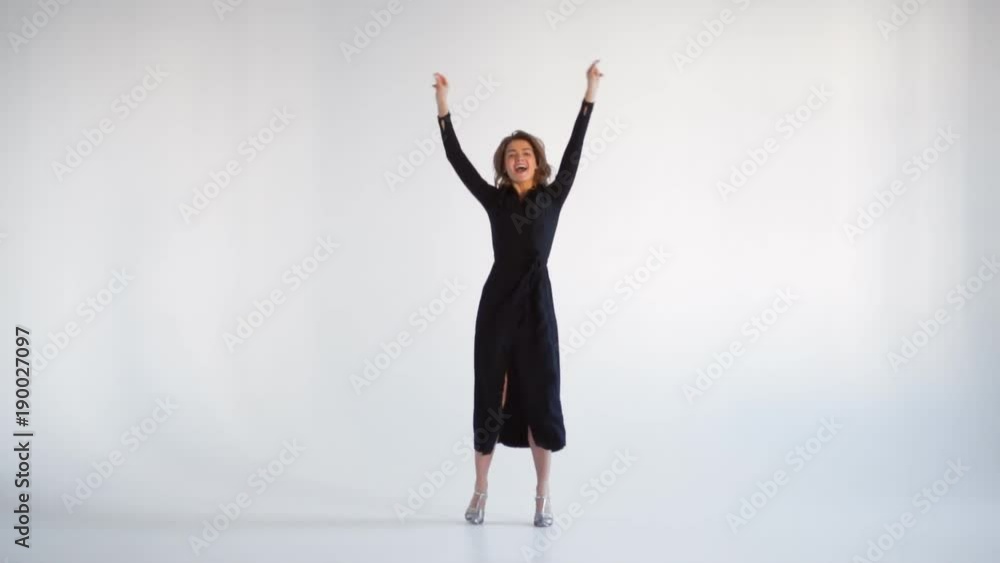 Pleased female in fluttering long dress dancing Pleased female in fluttering long dress dancing