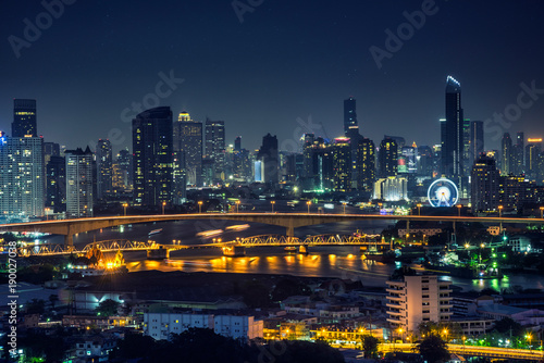 Bangkok thailand cityscape at night many tower near river