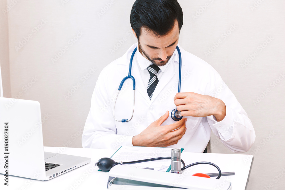 Doctor and stethoscope working with laptop computer in hospital.healthcare and medicine Doctor and stethoscope working with laptop computer in hospital.healthcare and medicine