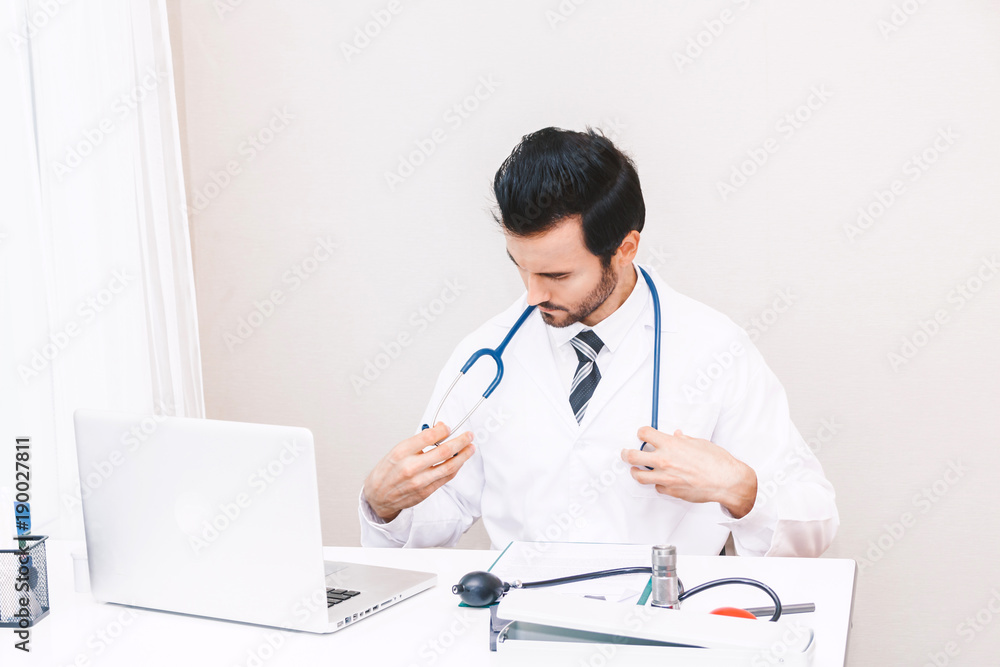 Doctor and stethoscope working with laptop computer in hospital.healthcare and medicine Doctor and stethoscope working with laptop computer in hospital.healthcare and medicine