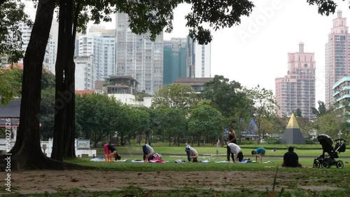 People practice yoga class in outdoor park, exercise work out and healthy lifestyle concept. time lapse