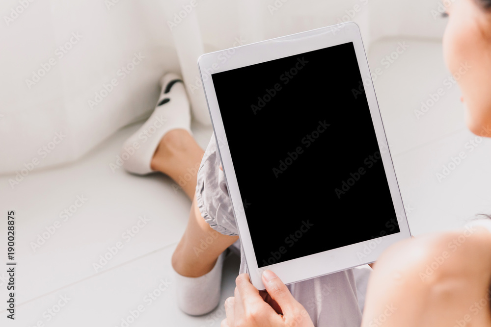 Woman using digital tablet computer in bedroom - obrazy, fototapety, plakaty 