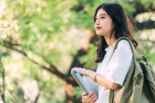 Fotografie Woman students holding notebooks outdoors.Education concept