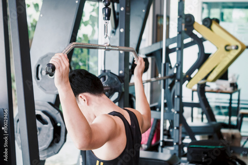 Fitness man execute exercise with exercise-machine at the gym