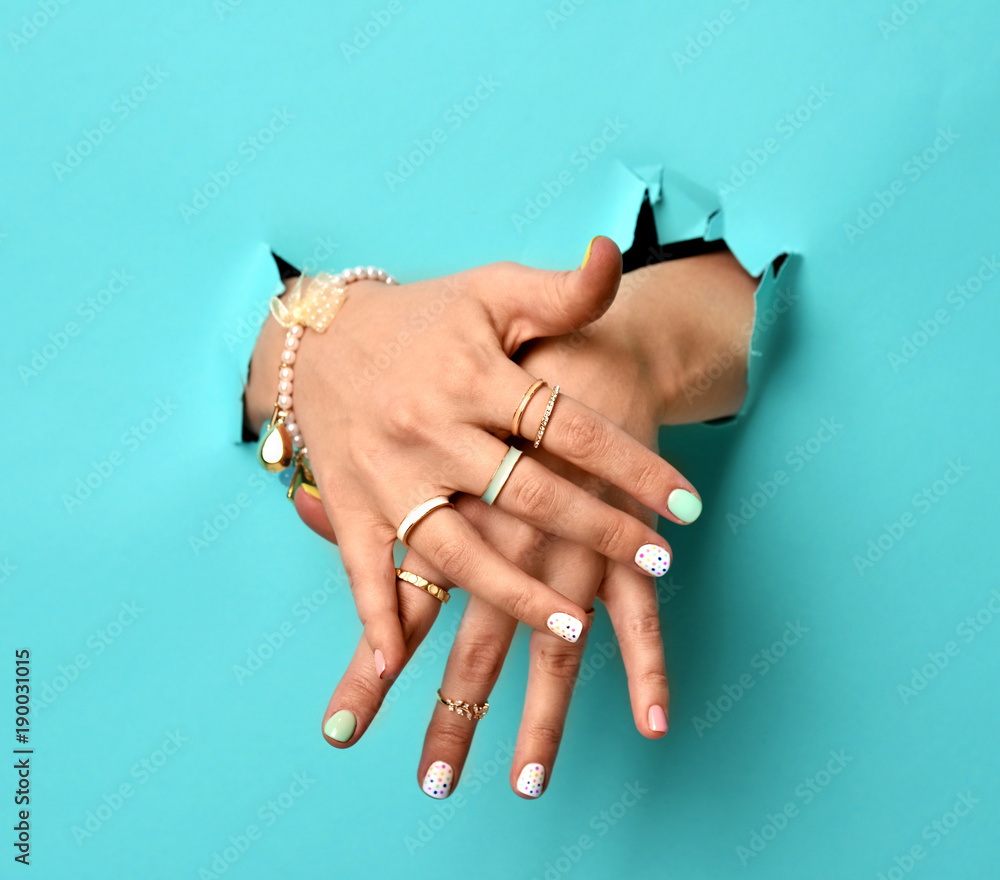 Female hands with manicure close up. Many beautiful gold rings on female  fingers, vintage wooden background. Jewelry and nail beauty. Stock Photo |  Adobe Stock