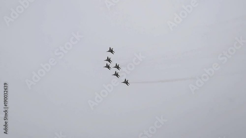 Air show in the sky above the Krasnodar airport flight school. Airshow in honor of Defender of the Fatherland. MiG-29 in the sky.