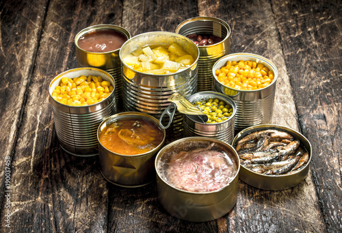 Various canned vegetables, meat, fish and fruits in tin cans. photo