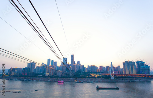 steel cable over river and modern cityscape