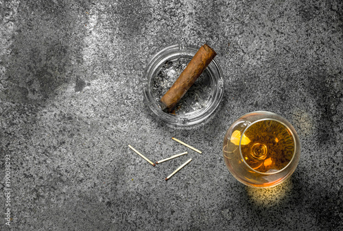 glass of cognac with a cigar.