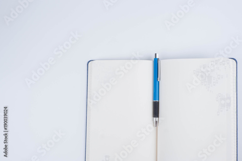 Top view Note Book and blue Pen on white background for Take note in Business Planning,job,study, photo