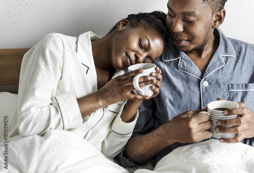 A couple having coffee in bed