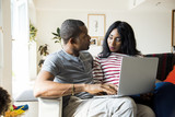 African couple working on laptop
