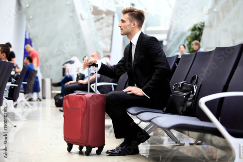 A businessman sitting in the airport.