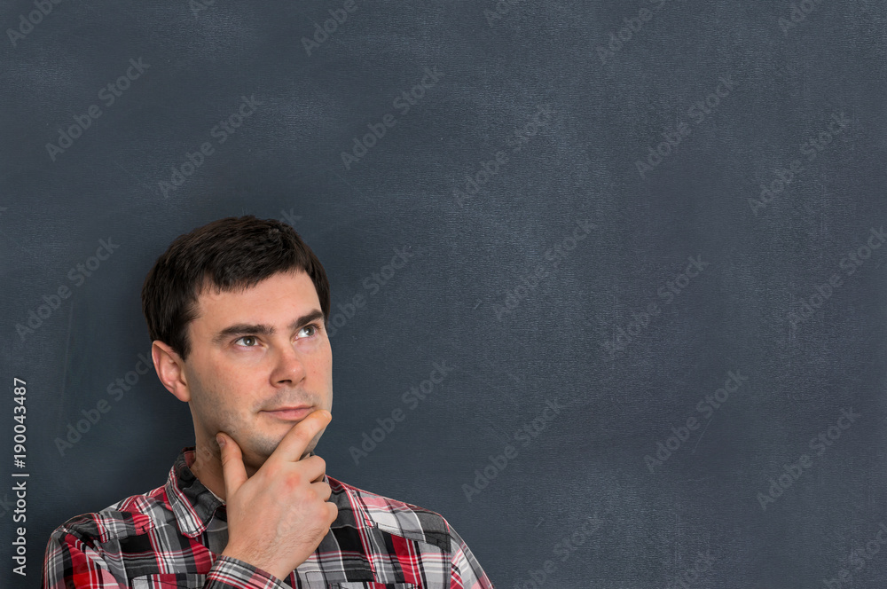 Thoughtful man with empty blackboard Thoughtful man with empty blackboard