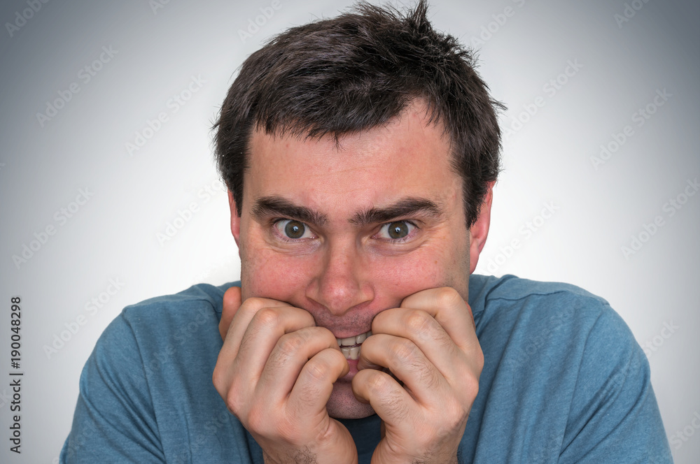 Fototapeta premium Nervous man biting his nails - nervous breakdown