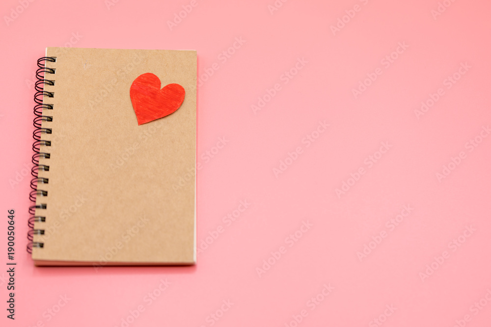 Paper red heart and Blank notebook with Pink Pastel plastic texture background. Valentine concept. Minimal concept. Copy space Paper red heart and Blank notebook with Pink Pastel plastic texture background. Valentine concept. Minimal concept. Copy space
