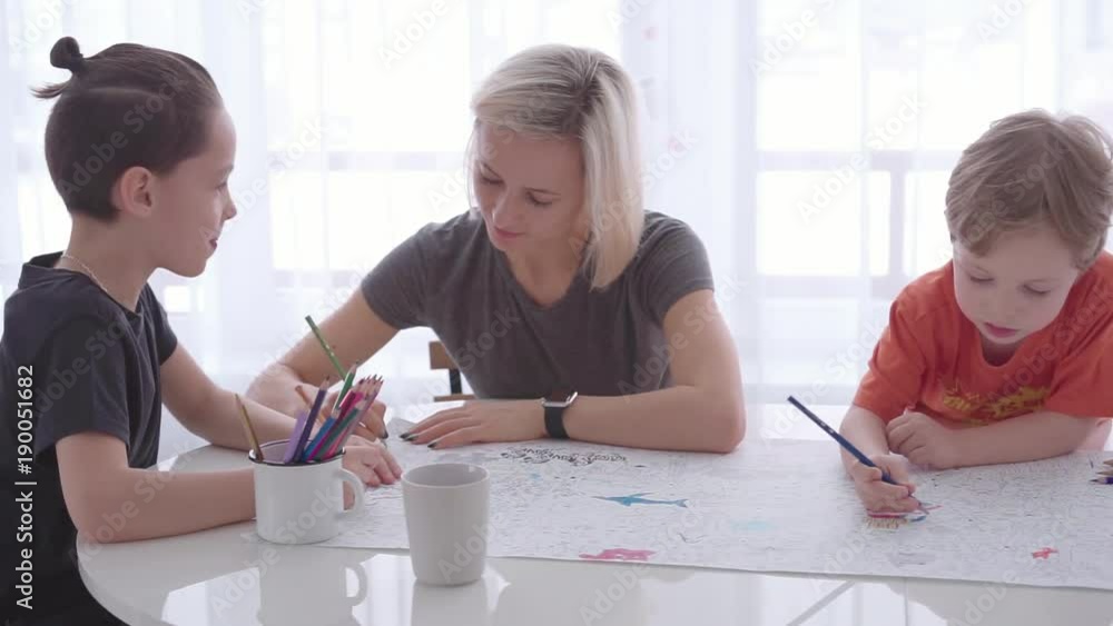 Mother and son drawing with pencil together Mother and son drawing with pencil together