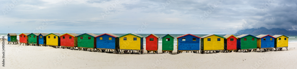Naklejka premium Ultra wide panorama of the colourful beach houses on Muizenberg beach - a popular tourist attraction near Cape Town, South Africa