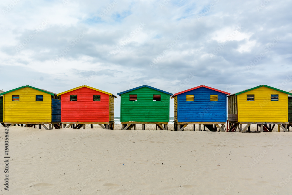 Fototapeta premium The colourful beach huts on Muizenberg beach - a popular tourist attraction near Cape Town, South Africa