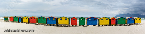 Ultra wide panorama of the colourful beach houses on Muizenberg beach - a popular tourist attraction near Cape Town, South Africa