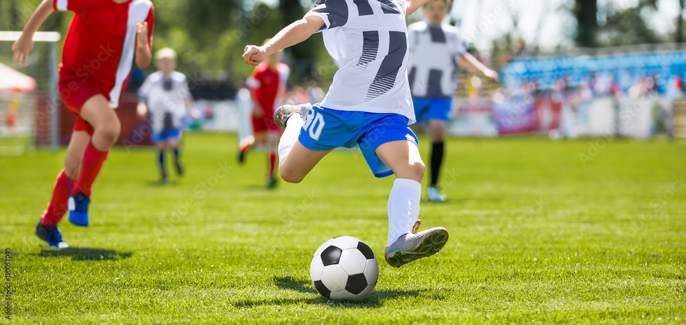 Soccer Football Kick. Young Player Kicking Soccer Ball. Footballers Running the Ball