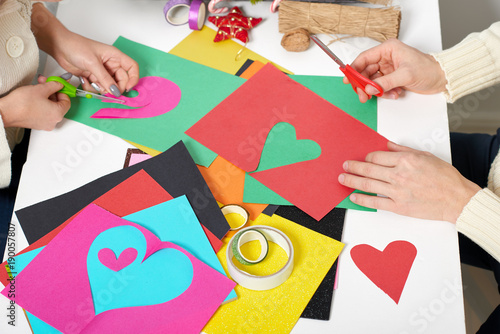young couple making origami decorations for Valentine day, top view - romantic and love concept