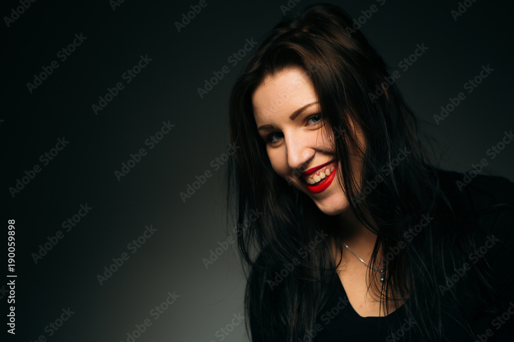emotional girl smiling on a dark background emotional girl smiling on a dark background