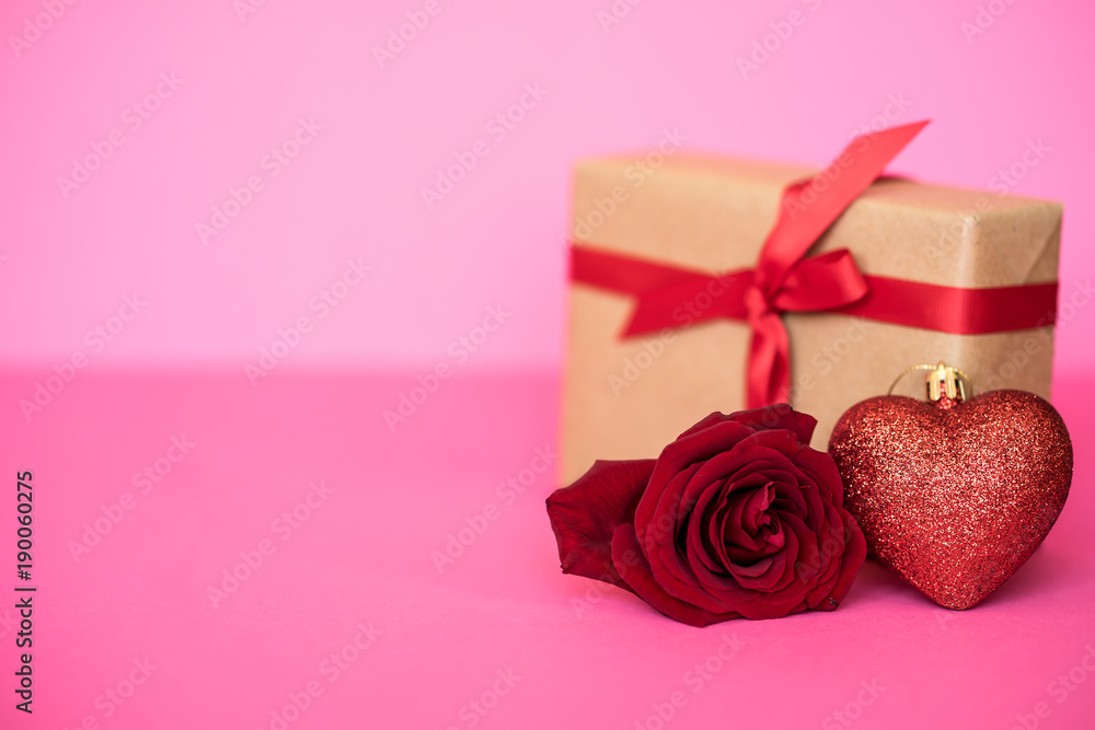 Romantic background with roses and gift box on pink.The concept of St. Valentine's Day, weddings, birthday or International Women's Day. Romantic background with roses and gift box on pink.The concept of St. Valentine's Day, weddings, birthday or International Women's Day.