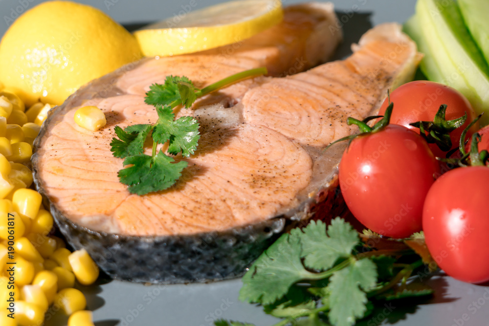 closed-up grilled fish salmon fillet with fresh vegetable, food and vegetable concept closed-up grilled fish salmon fillet with fresh vegetable, food and vegetable concept