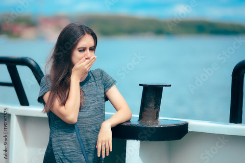 Sea sick woman suffering motion sickness while on boat photo