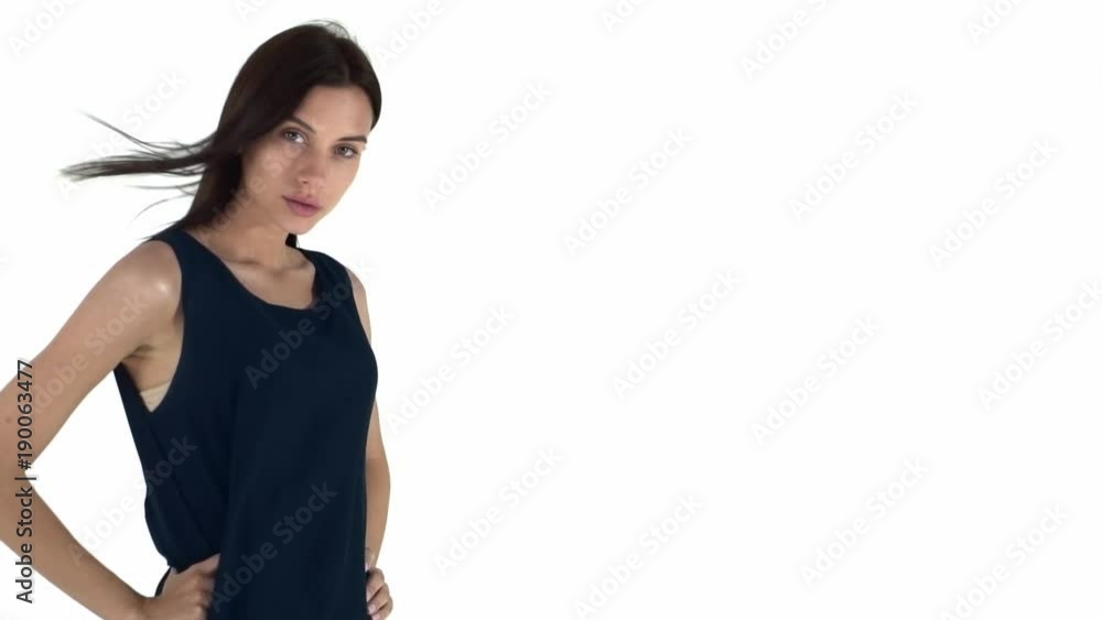 Beautiful and sexy young woman in a blue dress with dark hair. Slow motion