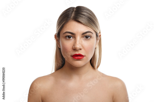Gorgeous female with blonde hair and red lips posing nude in studio, standing close to her bearded husband before going to bed. People, relationships, sex, sexuality, passion and sensuality concept
