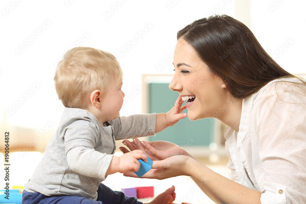 Baby and mother playing together on the floor Baby and mother playing together on the floor